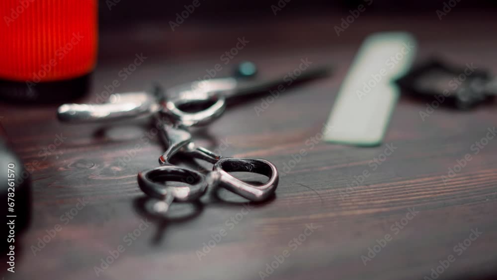 Close-up of metal shiny scissors for hairdressers on a wooden table. Professional tools for craftsmen. Close-up of metal shiny scissors for hairdressers on a wooden table. Professional tools for craftsmen.