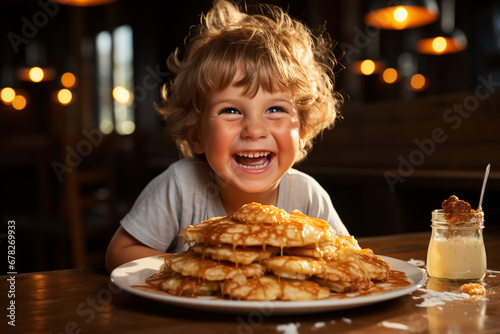 happy child eating pancakes in the kitchen