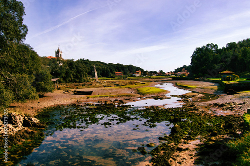 View of a wreck boat in the river and the church in the spanish countryside