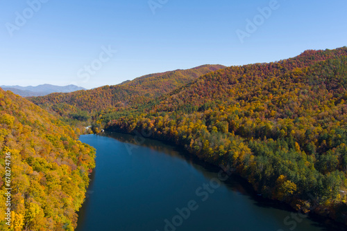 High angle view of Lake Logan and vibrant autumn colors in the Blue Ridge Mountains of North Carolina, USA.
