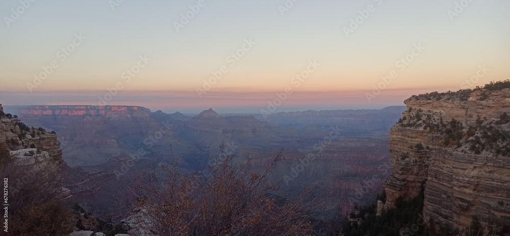 As the sun dips below the horizon, the Grand Canyon is enveloped in a captivating glow. This image, titled 