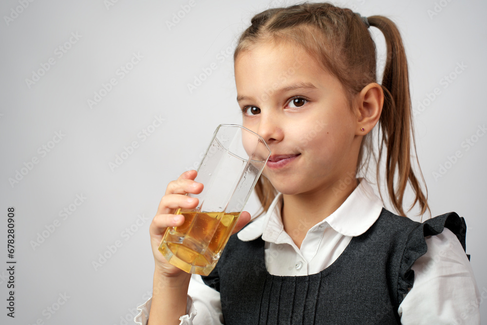 Portrait of happy little girl drinking apple juice from glass Portrait of happy little girl drinking apple juice from glass