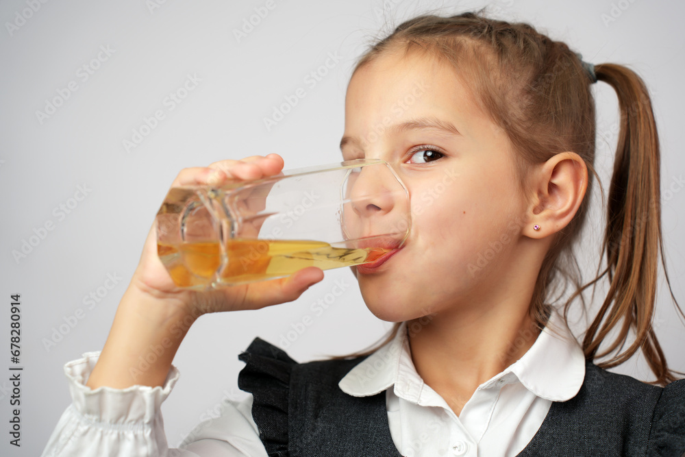 Portrait of happy little girl drinking apple juice from glass Portrait of happy little girl drinking apple juice from glass