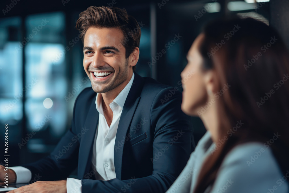 Man and woman are sitting at table, focused on their laptop. This image can be used to depict teamwork, collaboration, or working together on project Man and woman are sitting at table, focused on their laptop. This image can be used to depict teamwork, collaboration, or working together on project