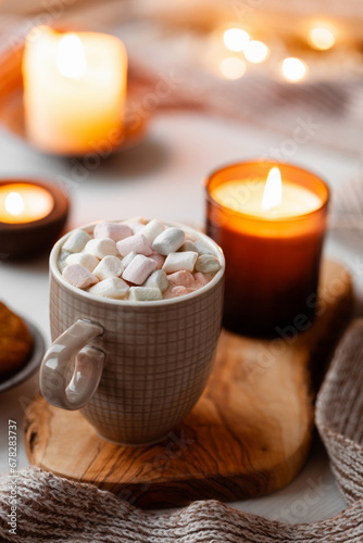 warm cozy window arrangement, winter or autumn concept, coffe, candles throw lights