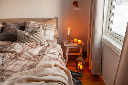 cozy scandinavian bedroom interior in natural tones  blanket candles