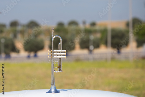 Silver coloured trumpet in the open air. october 1st international day of music.