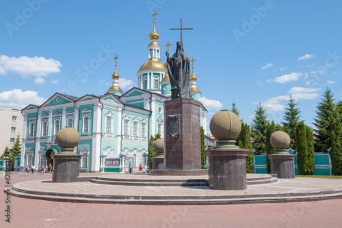 Monument to St. Pitirim Bishop of Tambov against the background of the ancient Transfiguration Cathedral on a sunny June day. Tambov, Russia photo