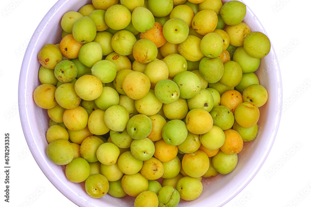 Fresh yellow  plums, light green plums background.