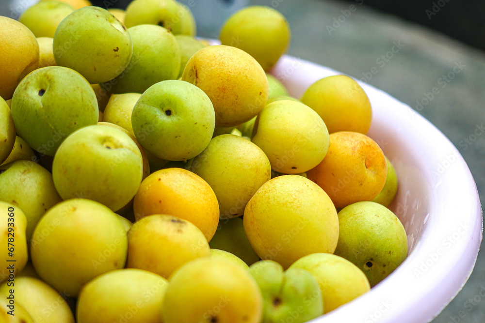 Fresh yellow plums, light green plums background. Fresh yellow plums, light green plums background.