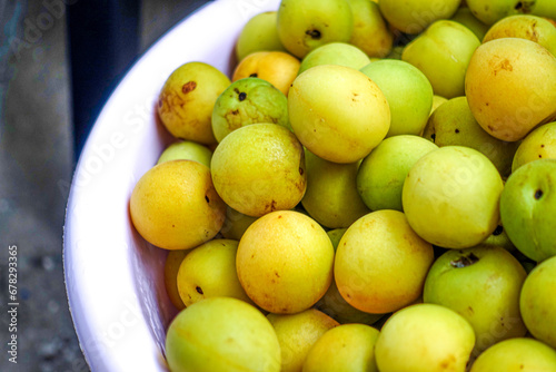 Fresh yellow  plums, light green plums background.