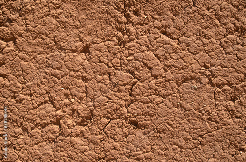 Old mud wall plaster with cracks closeup