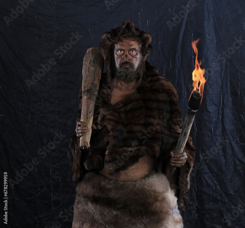 caveman with a torch, black background