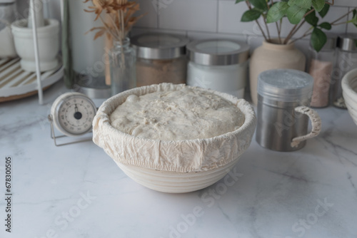 The proofing of sourdough bread is made in the Benetton basket. Home baking.