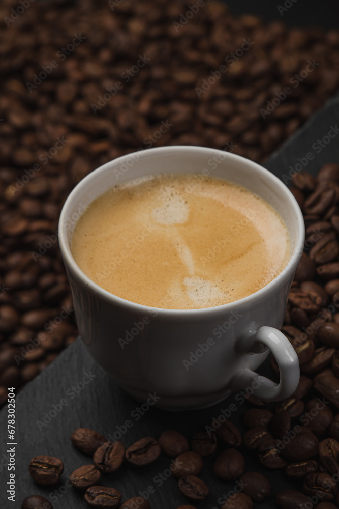 Cup of espresso coffee on a background of coffee beans Cup of espresso coffee on a background of coffee beans