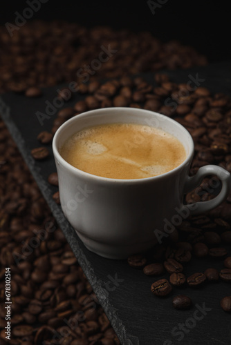 Cup of espresso coffee on a background of coffee beans