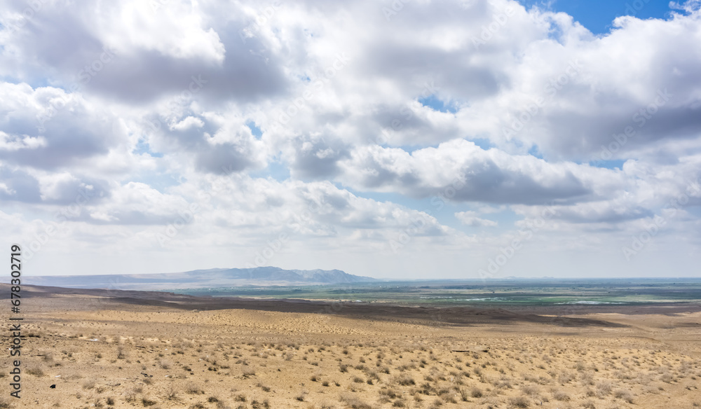 Panoramic view of a mountain range in the desert in cloudy summer weather Panoramic view of a mountain range in the desert in cloudy summer weather
