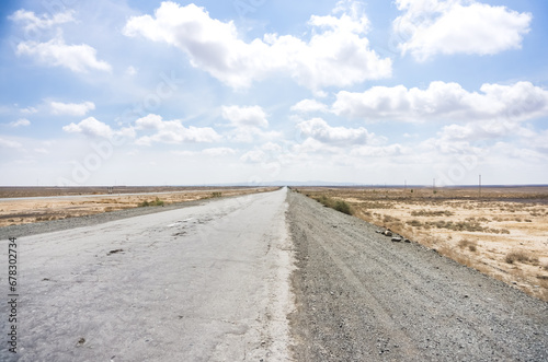 Asphalted highway in the middle of the desert in Uzbekistan, bad road in the desert