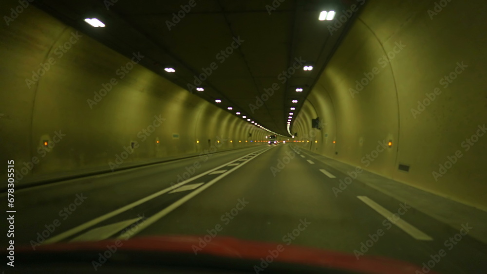 Car passenger POV inside tunnel in hectic speed. Vehicle journey commute perspective