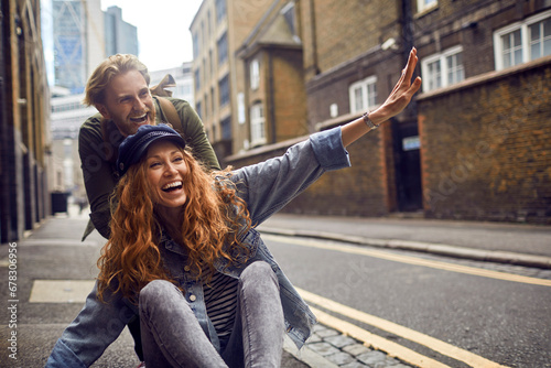 Happy young couple having fun on city streets photo