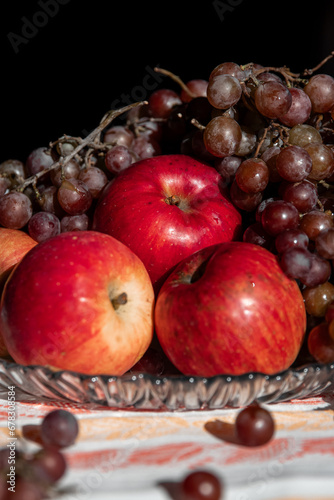 autumn still life. apples and grapes. fruits in a plate. red apple. food. fruits. autumn. 