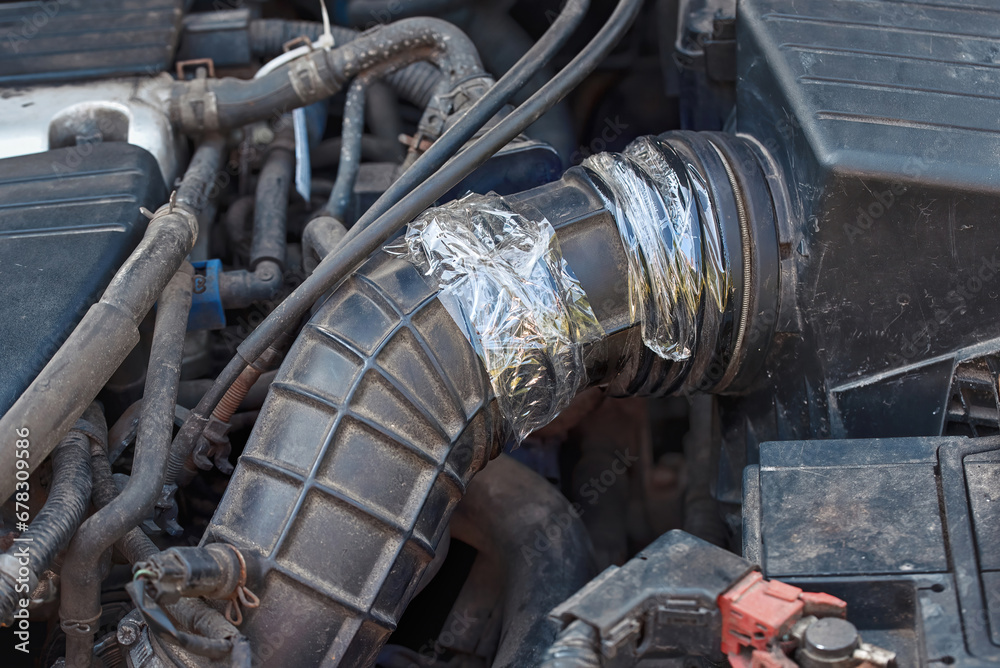 Air intake hose temporary repair with transparent duct tape. Air intake