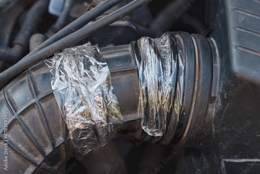 Air intake hose temporary repair with transparent duct tape. Air intake