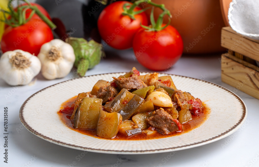 Top view of Turkish dish Guvech - baked meat with eggplant and traditionally served in earthenware pot (Turkish name; etli patlican guvec or patlican tava)