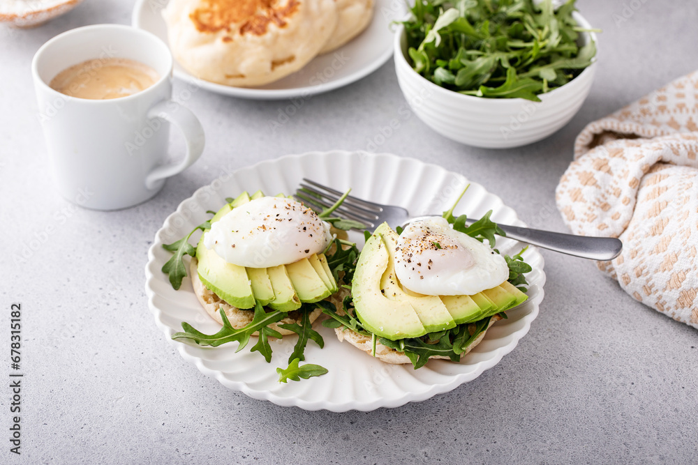 English muffins with arugula, avocado and poached eggs, healthy eggs benedict English muffins with arugula, avocado and poached eggs, healthy eggs benedict