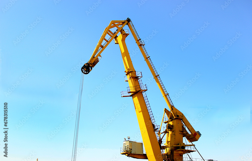 Yellow crane against blue sky