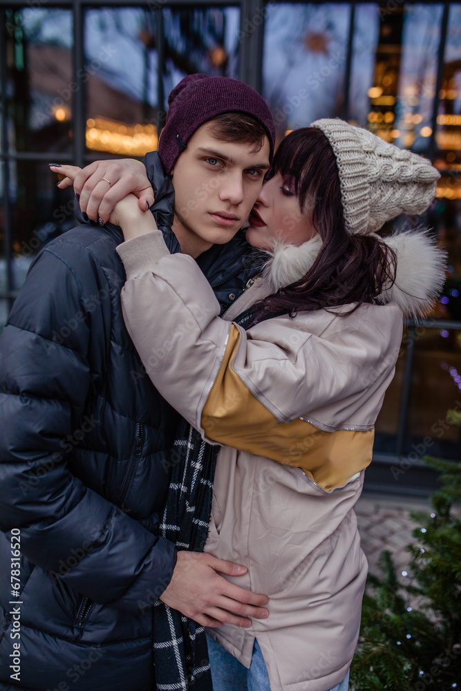 Naklejka premium Couple in love in winter on Christmas eve walking