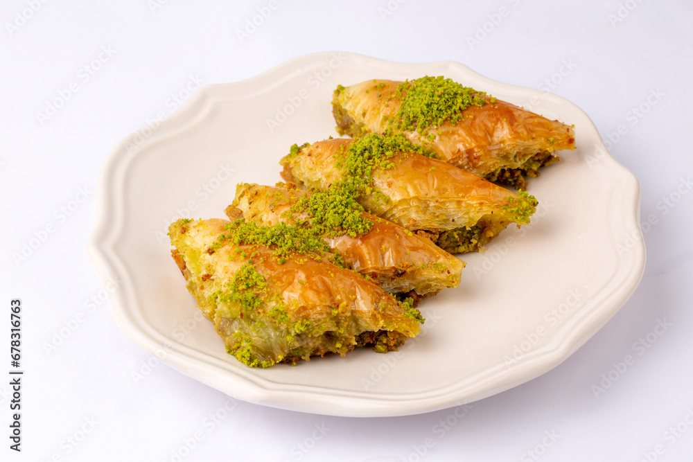 Turkish Dessert Sobiyet Baklava. Turkish pistachio baklava on a white background. Local name şöbiyet baklava