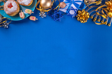 Happy Hanukkah greeting card background. Jewish New Year holiday flat lay with traditional symbols of hanukkah festival, menorah, donuts and decorations copy space