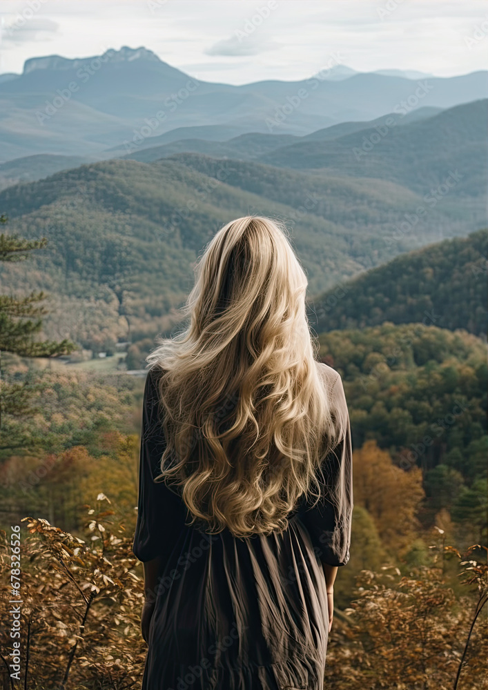 Woman with long wavy blond hairs with nature in background. Dense long blonde hair rear view Woman with long wavy blond hairs with nature in background. Dense long blonde hair rear view