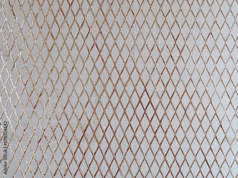 silver steel mesh in front of grey concrete wall, diagonal metallic grating for hanging products display in stall at flea market - obrazy, fototapety, plakaty 