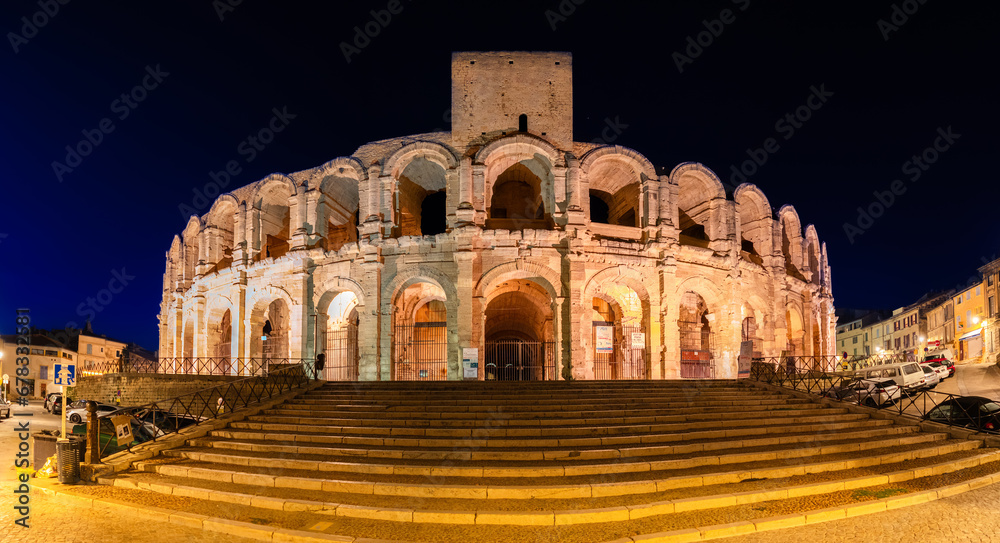 Arles, France - October 1, 2023: Panorama of the illuminated Roman amphitheater and the arena of Arles in the night