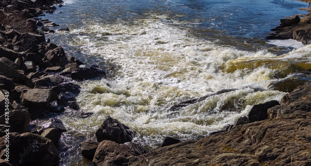 Fototapeta premium Spring landscape with waterfall on the northern river with stone banks