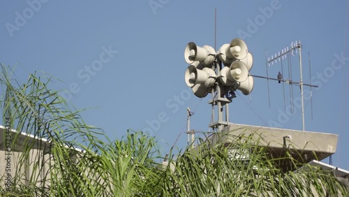 Eight loud alarm siren speakers for civil protection installed on the roof of a defense tower in Israel. This system enhances public safety and emergency alerts. Sound amplifier 