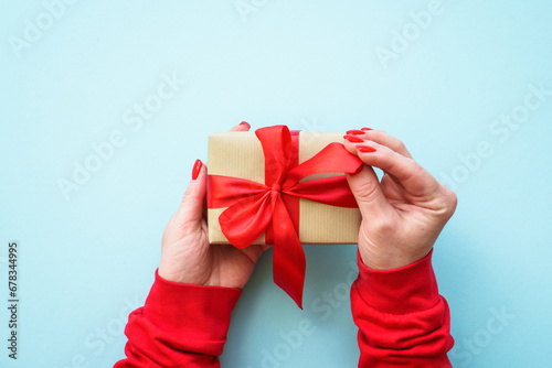 Fototapeta Naklejka Na Ścianę i Meble -  Boxing day, christmas present. Woman giving christmas present. Top view image.