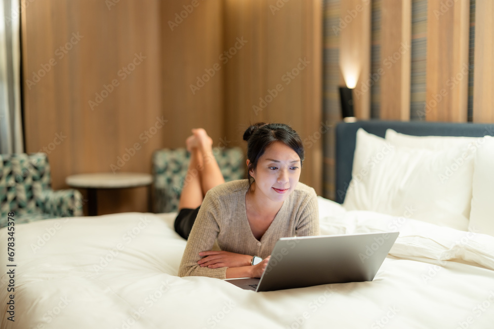 Woman lying on the bed and use of laptop computer