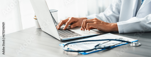 Doctor carefully review detailed medical report with laptop and diagnosing illness for effective healthcare treatment plan for patient in doctor office. Professional medical evaluation. Neoteric photo