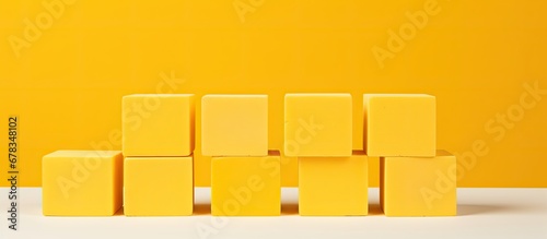 Yellow background with concrete cubes representing business strategy and action plan concept providing copy space