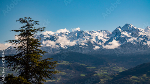 Alpine glory near Grenoble, with clouds kissing mountains. © Alix Millet
