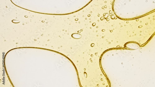 Transparent cosmetic gel fluid with molecule bubbles oil distribution on a white background. Macro Shot of Natural Organic Cosmetics, Medicine. Production Close-up. Slow Motion. High quality 4k