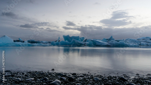 Serene icebergs on a calm Icelandic lagoon.