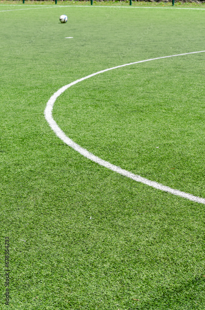 Detail of the center of an artificial grass 7-a-side football field.