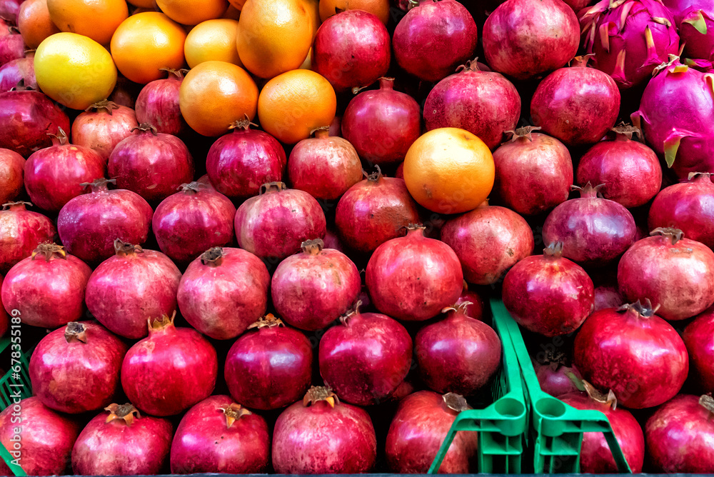Pomegranate garnet fruit background pattern. Pomegranate whole with flower. Fresh raw organic garnet fruit pile texture background. Ruby natural pomegranate (garnet fruit) heap close up top view. Pomegranate garnet fruit background pattern. Pomegranate whole with flower. Fresh raw organic garnet fruit pile texture background. Ruby natural pomegranate (garnet fruit) heap close up top view.