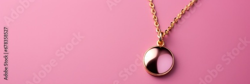 A delicate minimalist golden pendant necklace isolated on a pink gradient background  photo
