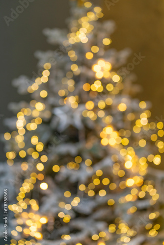 Christmas room with golden bokeh. A blurry image of an atmospheric Christmas Eve. Unfocused Christmas tree with backlit close-up.
