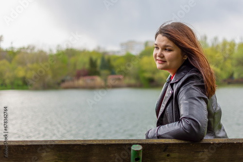 Happy girl resting on a bench on the shore of the lake © Alexandr Macovethi